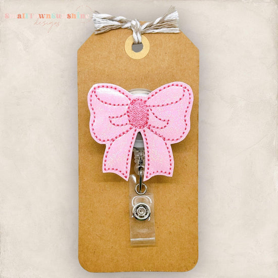 pretty pink bow badge reel