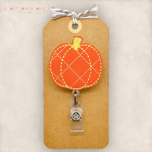 orange pumpkin with a gold diamond print, embroidered badge reel cover