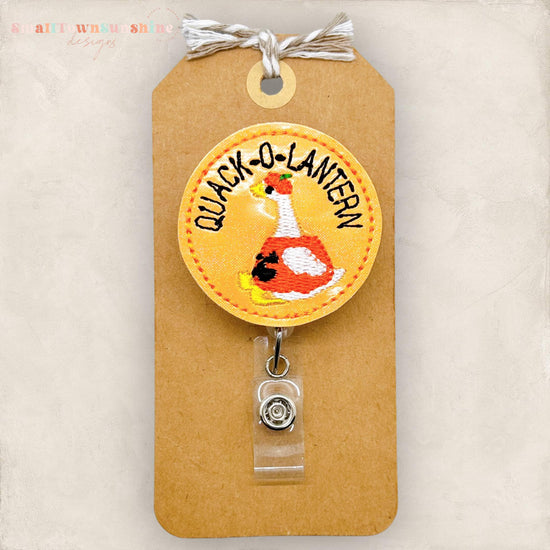 quack o lantern, duck dressed as halloween pumpkin badge reel