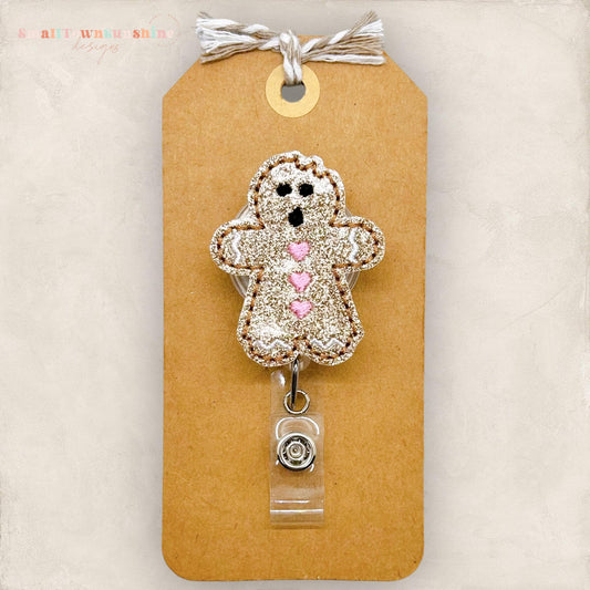 gingerbread cookie with bite out of the head badge reel