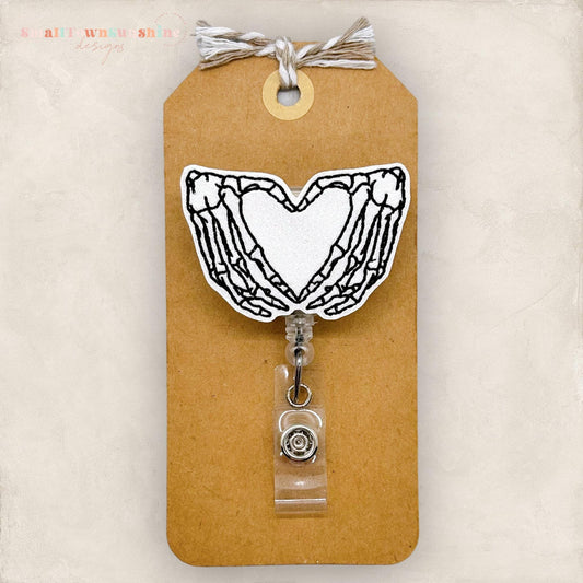 skeleton hands making a heart shape embroidered badge reel