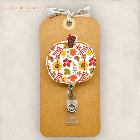 embroidered pumpkin with a fall leaf print for badge reels