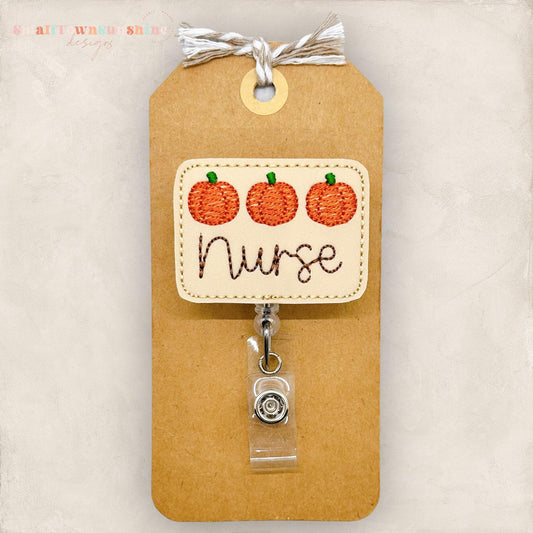 3 embroidered pumpkins with the word nurse for a badge reel