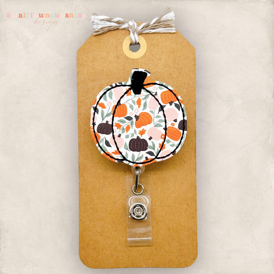 embroidered pumpkin with a pumpkin patch print, badge reel cover