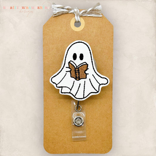cute ghost reading a brown book embroidered badge reel