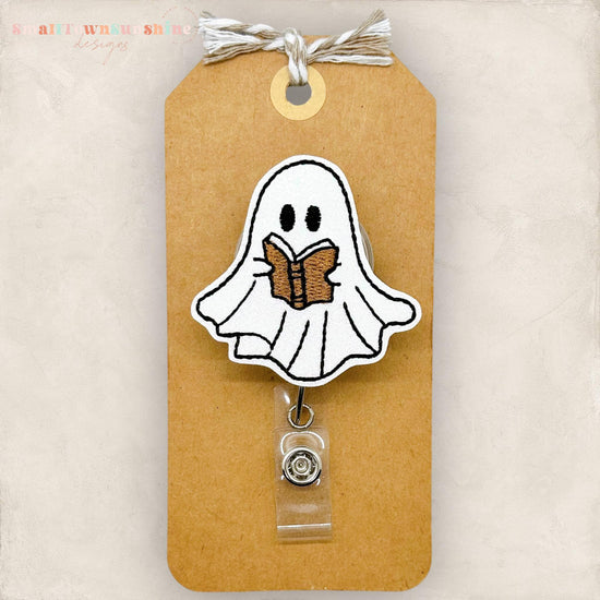 cute ghost reading a brown book embroidered badge reel