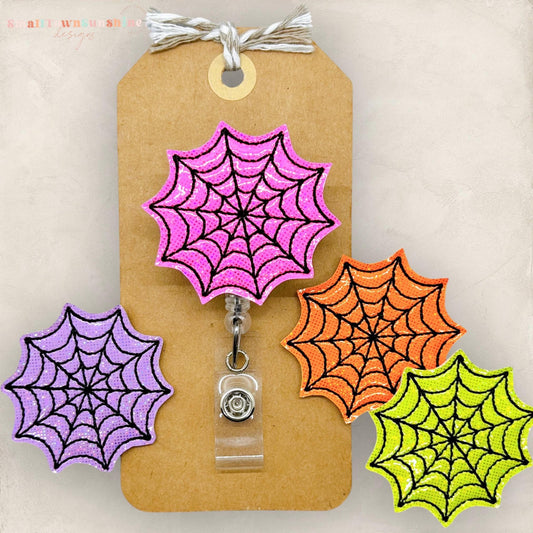 bright colored spiderweb embroidered badge reel toppers, pink, purple, orange, yellow