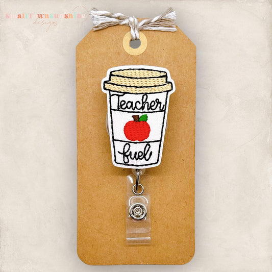 embroidered coffee cup with teacher fuel and an apple, badge reel cover