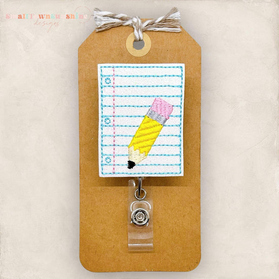lined paper with pencil embroidered badge reel