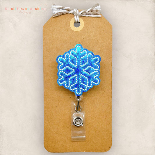 small blue holographic snowflake badge reel