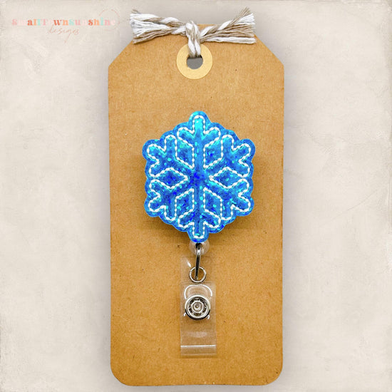small blue holographic snowflake badge reel
