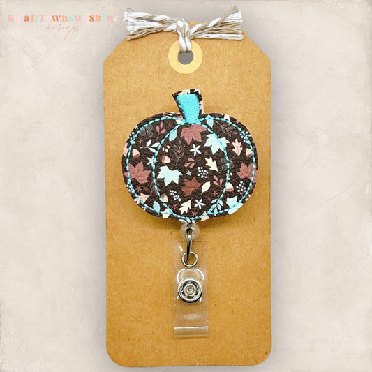 vegan leather embroidered pumpkin with brown and teal fall leaves badge reel topper