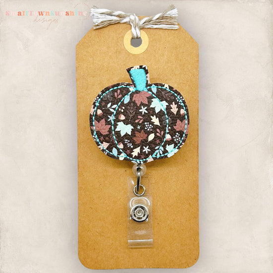 vegan leather embroidered pumpkin with brown and teal fall leaves badge reel topper