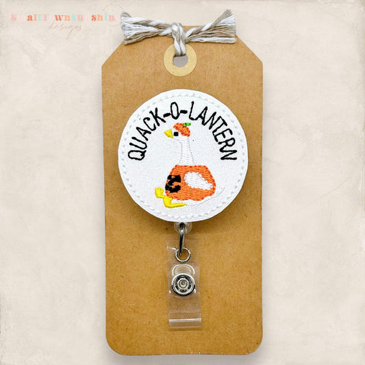 glittery white quack o lantern embroidered badge reel