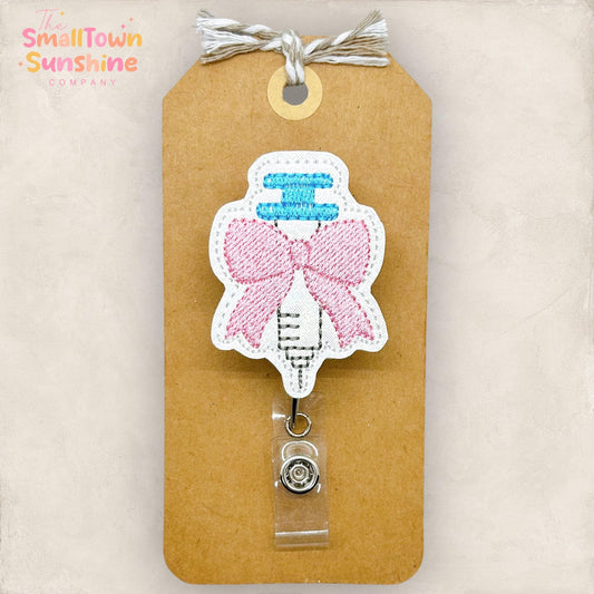 coquette pink bow syringe embroidered badge reel topper