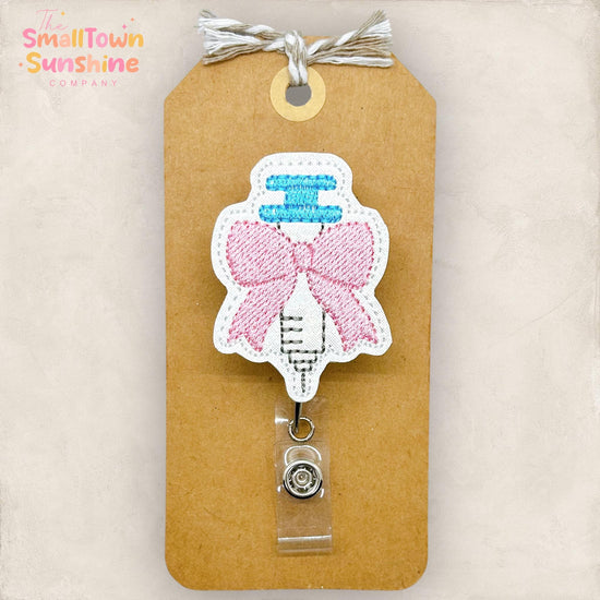 coquette pink bow syringe embroidered badge reel topper