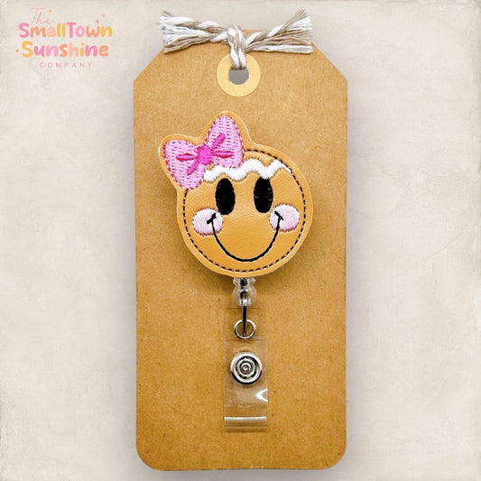 gingerbread girl face with pink bow badge reel topper